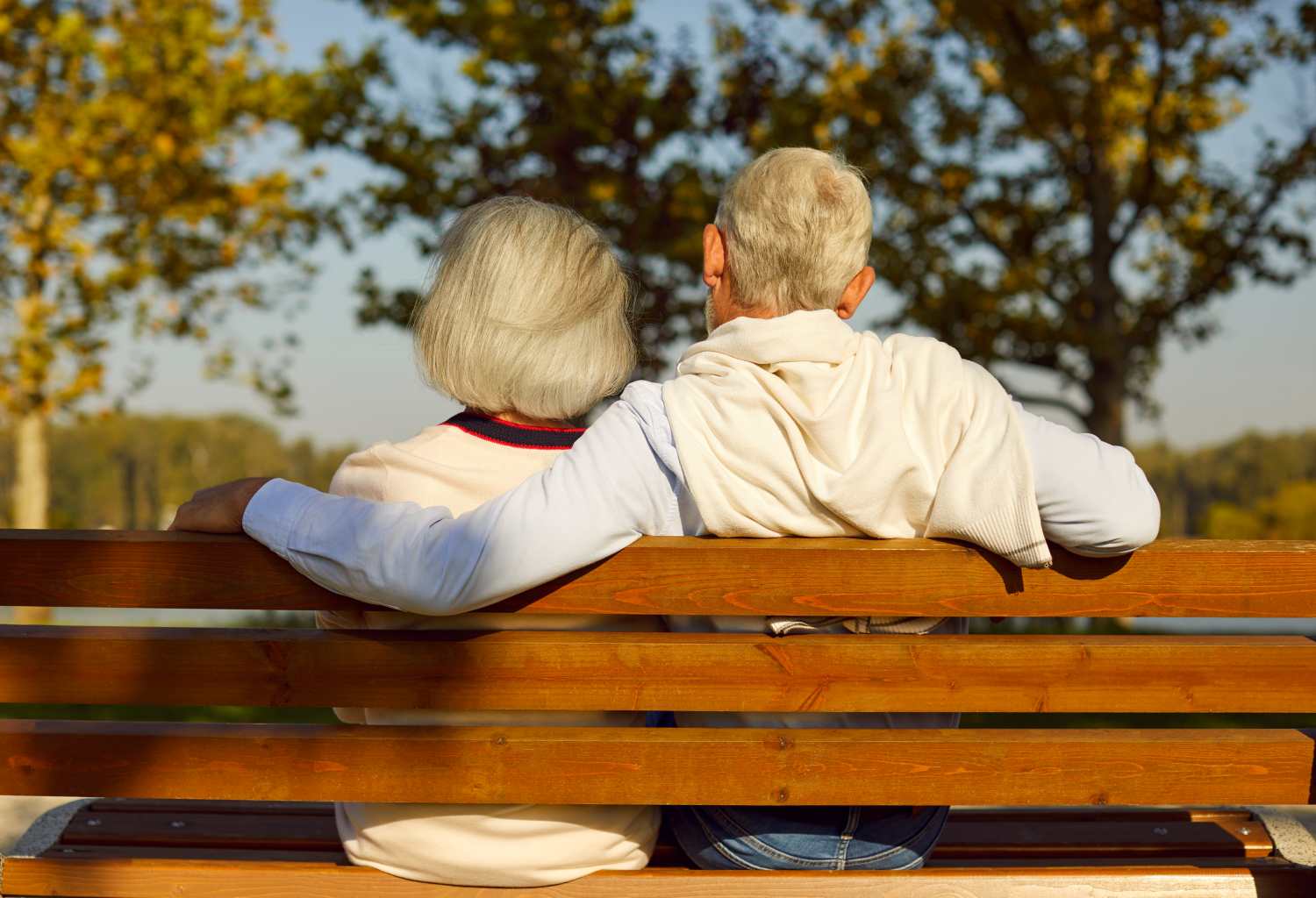 A senior couple sitting on a bench