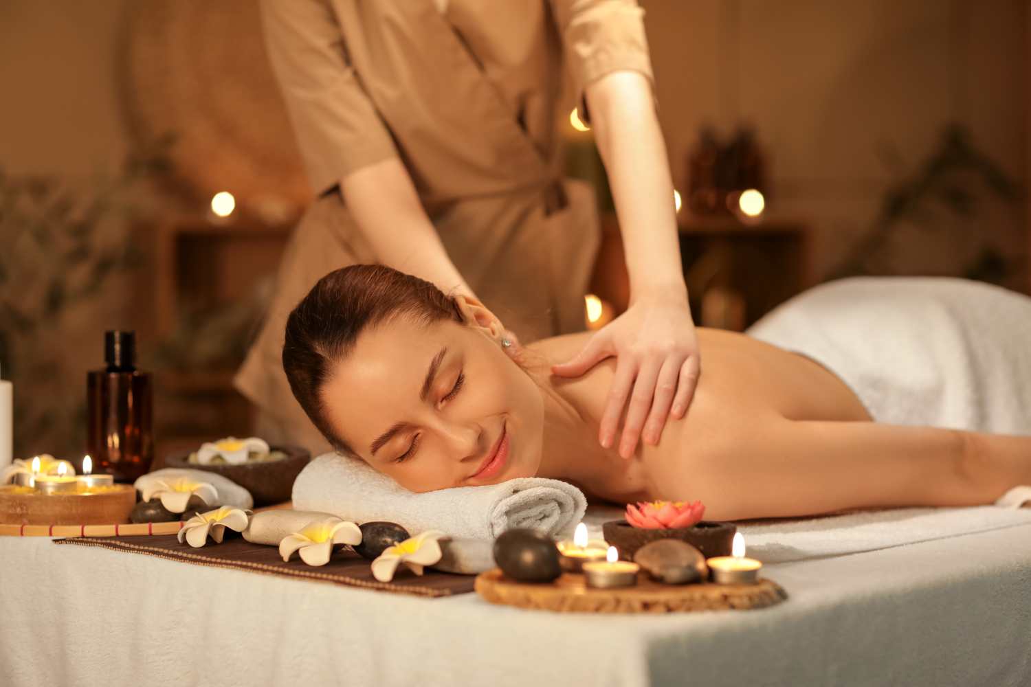 A woman getting a back massage at a spa